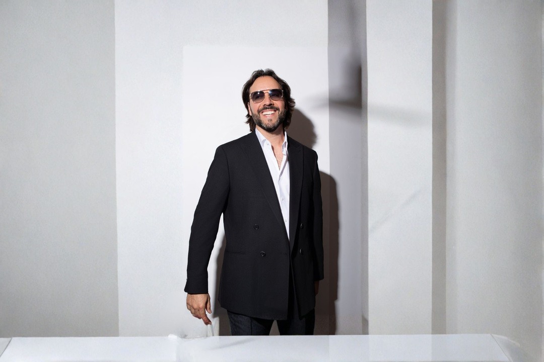 Mario Volta wearing a black suit and sunglasses